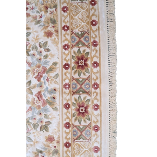 2127 - A CREAM GROUND FULL PILE ORBISON DESIGN RUG with circular central medallion on floral patterned... 