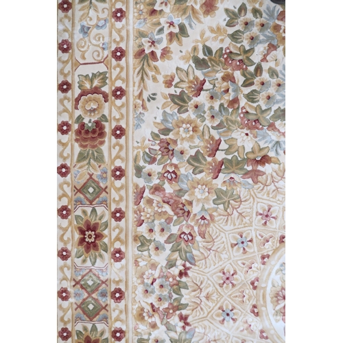 2127 - A CREAM GROUND FULL PILE ORBISON DESIGN RUG with circular central medallion on floral patterned... 