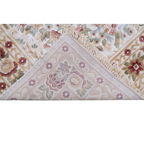 2127 - A CREAM GROUND FULL PILE ORBISON DESIGN RUG with circular central medallion on floral patterned... 