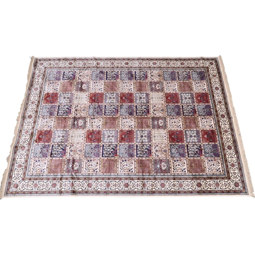 2129 - AN IVORY GROUND FULL PILE PERSIAN STYLE RUG  with multicoloured panel design within cream flora... 