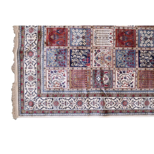 2129 - AN IVORY GROUND FULL PILE PERSIAN STYLE RUG  with multicoloured panel design within cream flora... 