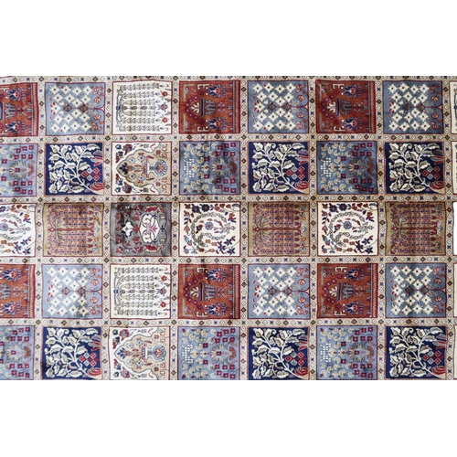 2129 - AN IVORY GROUND FULL PILE PERSIAN STYLE RUG  with multicoloured panel design within cream flora... 