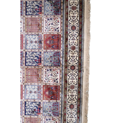 2129 - AN IVORY GROUND FULL PILE PERSIAN STYLE RUG  with multicoloured panel design within cream flora... 