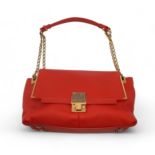 2674 - A LANVIN PARTITION SHOULDER BAGin orange leather, lined in red fabric, with two open pockets under t... 