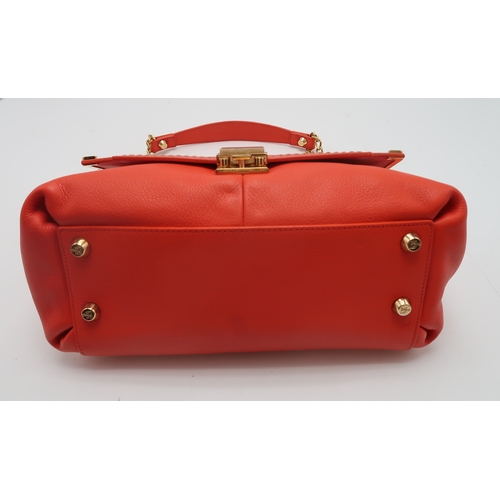 2674 - A LANVIN PARTITION SHOULDER BAGin orange leather, lined in red fabric, with two open pockets under t... 