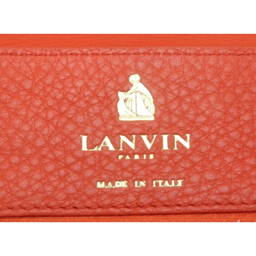 2674 - A LANVIN PARTITION SHOULDER BAGin orange leather, lined in red fabric, with two open pockets under t... 