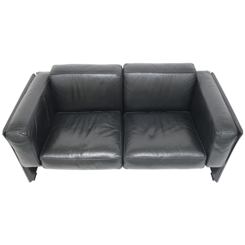 2085 - A 20TH CENTURY CASSINA TWO SEATER SETTEEwith black leather upholstered cushions on leather upholster... 