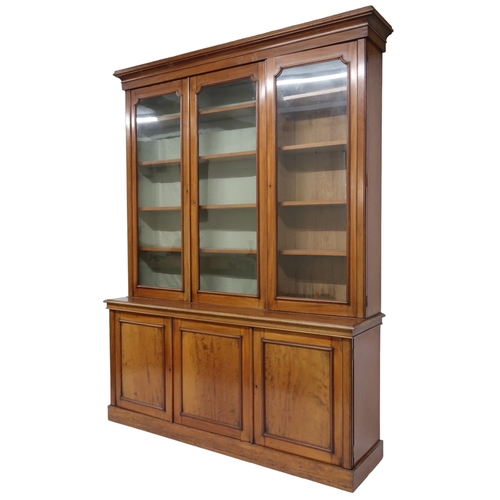 2032 - A VICTORIAN MAHOGANY LIBRARY BOOKCASE with moulded cornice over three glazed doors on base with... 