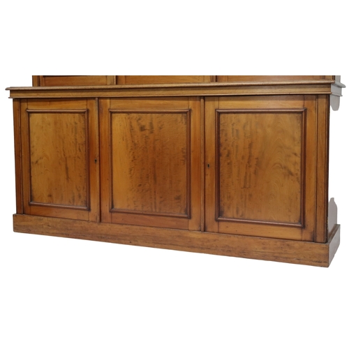 2032 - A VICTORIAN MAHOGANY LIBRARY BOOKCASE with moulded cornice over three glazed doors on base with... 