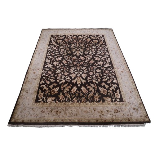 2121 - A LARGE DARK GROUND INDIAN WOOL ZEIGLER STYLE RUG with floral/foliate patterned ground within beige ... 