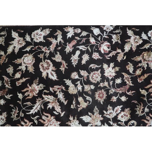 2121 - A LARGE DARK GROUND INDIAN WOOL ZEIGLER STYLE RUG with floral/foliate patterned ground within beige ... 