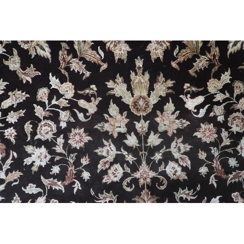 2121 - A LARGE DARK GROUND INDIAN WOOL ZEIGLER STYLE RUG with floral/foliate patterned ground within beige ... 