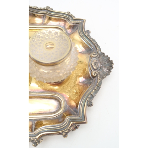 2531 - A GEORGE IV SILVER GILT INKSTANDby Richard Sibley, London 1827, of oblong lobed form, with a cast sc... 