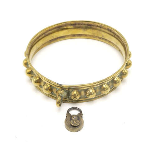 2668A - A 19th CENTURY BRASS DOG COLLARWith studded decoration, measuring approx. 12.5cm side-to-side and 13... 