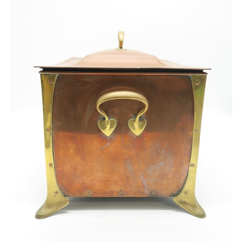 2317 - AN ARTS AND CRAFTS COPPER AND BRASS COAL BINof rectangular form with heart terminal handles to eithe... 