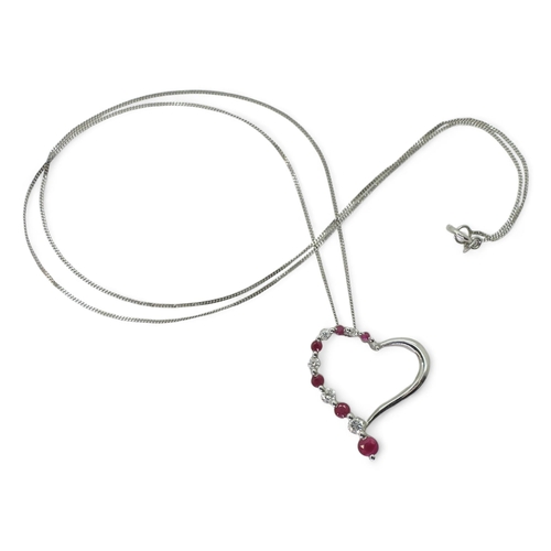 782 - A 9ct white gold ruby and diamond heart pendant, set with estimated approx 0.15cts of brilliant cut ... 