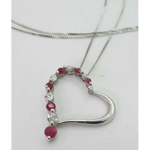 782 - A 9ct white gold ruby and diamond heart pendant, set with estimated approx 0.15cts of brilliant cut ... 