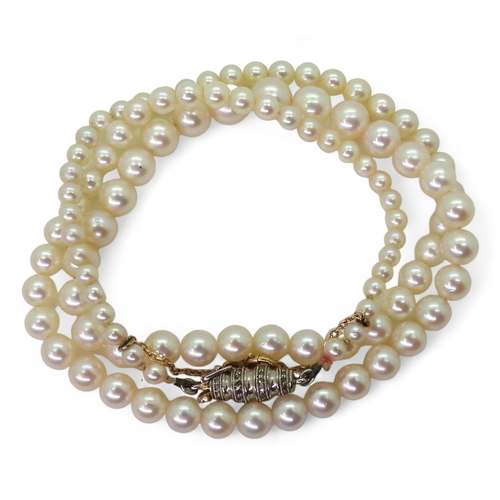 2797 - PEARLS WITH A DIAMOND CLASPthe white pearls have a pink lustre, and taper from 6.4mm to 2.9mm, with ... 