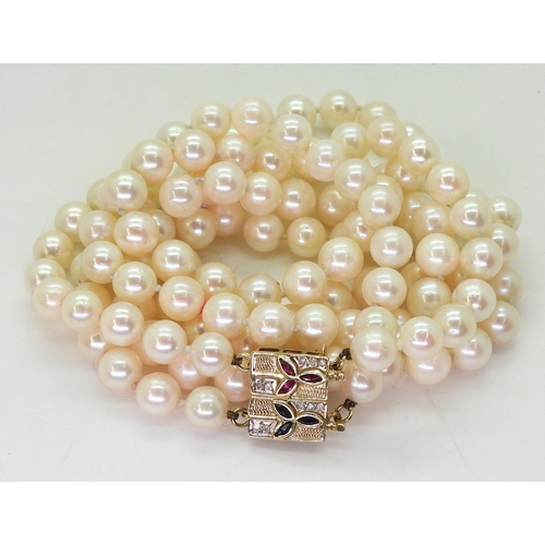 2829 - PEARLS WITH A METAMORPHIC CLASPthe double string of pearls has a ruby sapphire and diamond 14k gold ... 