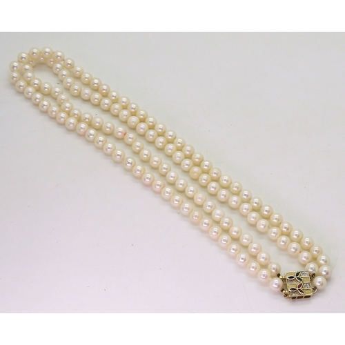 2829 - PEARLS WITH A METAMORPHIC CLASPthe double string of pearls has a ruby sapphire and diamond 14k gold ... 