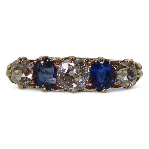 2832 - A FIVE STONE RINGset with two oval cut sapphires and three old cut diamonds with an estimated approx... 