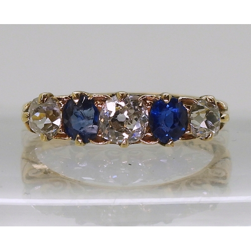 2832 - A FIVE STONE RINGset with two oval cut sapphires and three old cut diamonds with an estimated approx... 