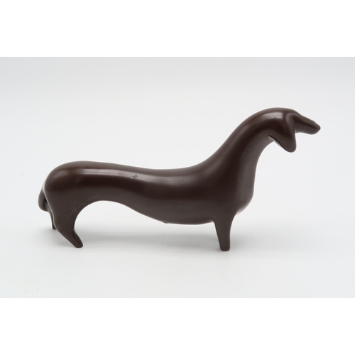 2286 - COLIN MELBOURNE FOR BESWICK  A 1950's figure of a Dachshund, in dark brown glaze, model 1469, stylis... 