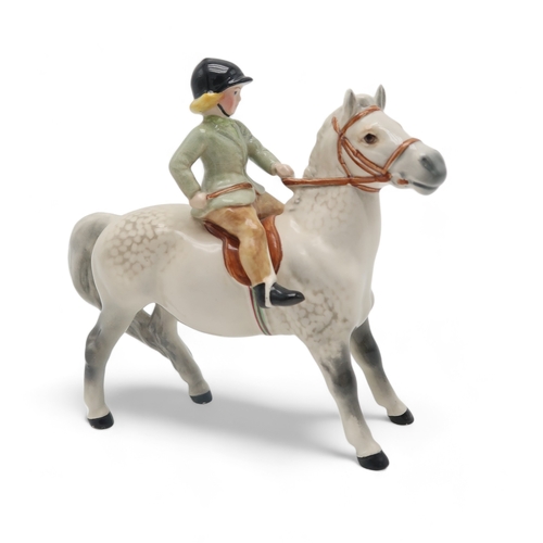 2292 - BESWICK GIRL ON LIGHT DAPPLE GREY PONYwearing a green jacket, model 1499