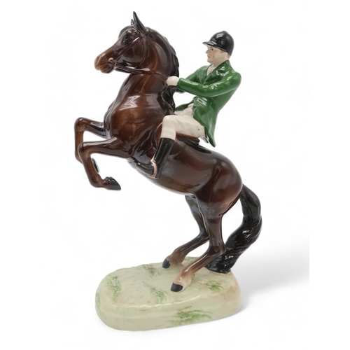 2297 - A BESWICK HUNTSMAN ON REARING HORSEwearing green jacket, model 868, printed and impressed marks to b... 