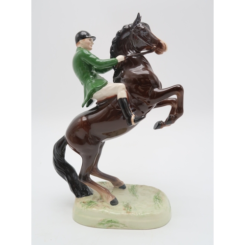 2297 - A BESWICK HUNTSMAN ON REARING HORSEwearing green jacket, model 868, printed and impressed marks to b... 