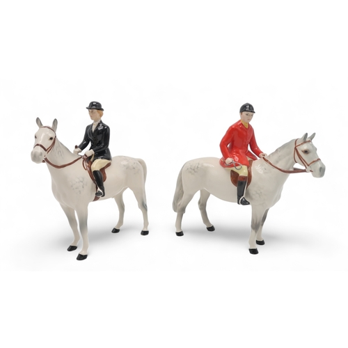 2302 - BESWICK HUNTSMAN IN RED JACKETon grey horse, model 1501 together with a Huntswoman in black jacket o... 