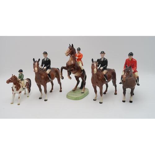 2305 - A BESWICK HUNTING GROUPincluding Girl on skewbald pony, model 1499, Boy on Palomino pony, model 1500... 