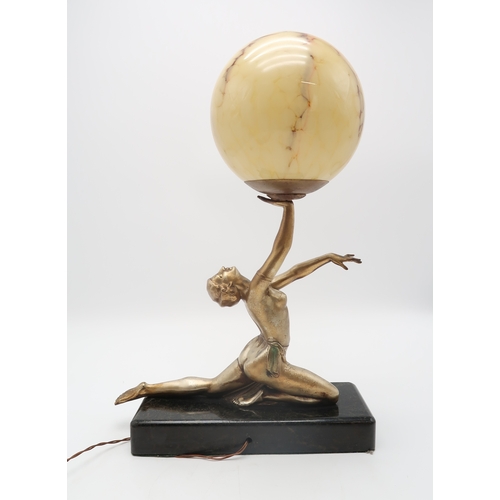 2319 - AN ART DECO GILDED METAL LADY LAMPmodelled kneeling with arms outstretched, balancing a mottled glas... 