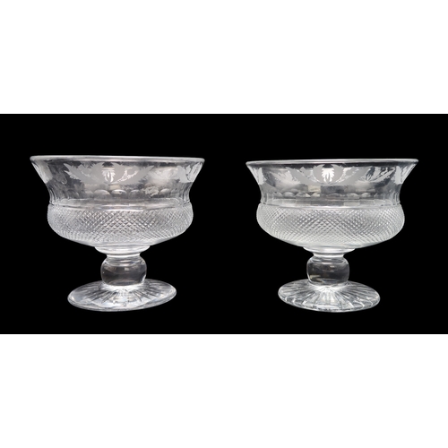 2321 - TWO EDINBURGH CRYSTAL THISTLE BOWLSwith diamond cut body with etched thistle band to rim, 17cm high,... 