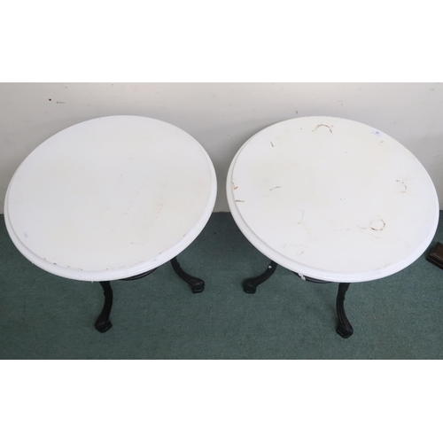 12 - A pair of late 19th/ early 20th century pub/bar tables with painted circular tops on cast iron bases... 