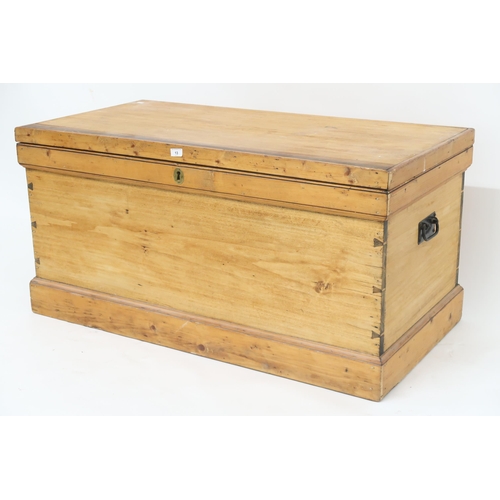 13 - A late Victorian pine blanket chest with iron carry handles on plinth base, 62cm high x 125cm wide x... 