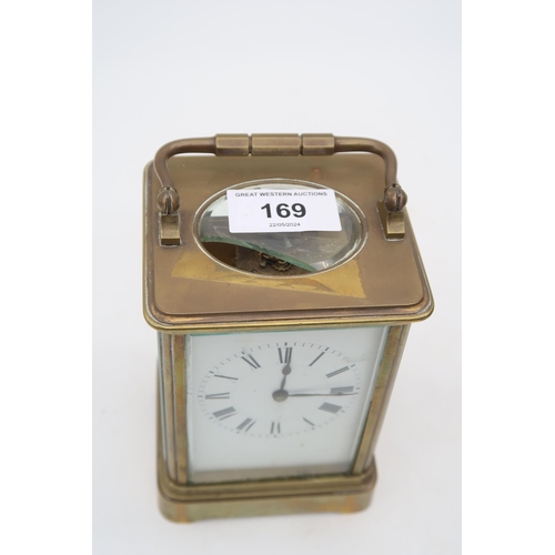 169 - A French brass and glass carriage clock with travel case