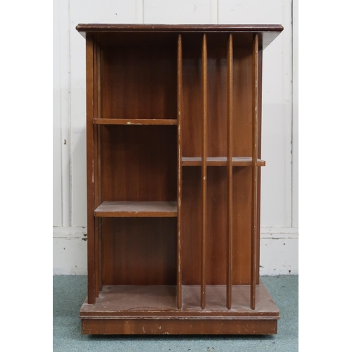 17 - An early 20th century mahogany revolving bookcase with square top over asymmetrical shelves with bat... 