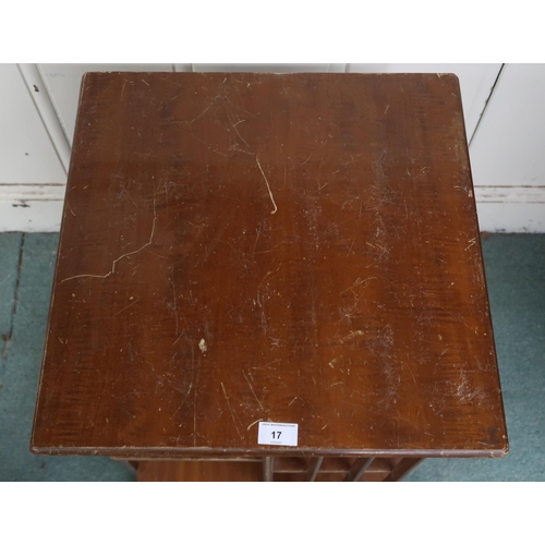 17 - An early 20th century mahogany revolving bookcase with square top over asymmetrical shelves with bat... 