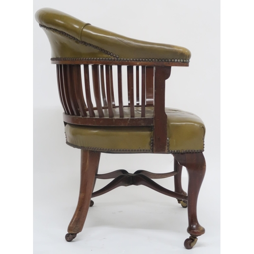 2 - An early 20th century captains style desk chair with green studded leather upholstered back rest and... 