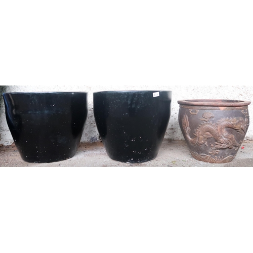 20A - A pair of contemporary black glazed terracotta planters, 40cm high x 49cm diameter and another conte... 