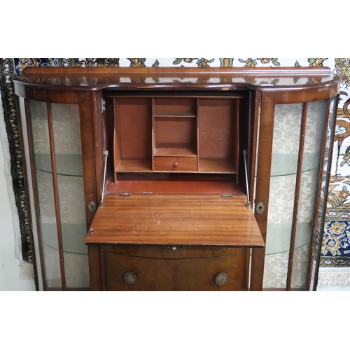 24 - An early 20th century walnut veneered serpentine front bureau bookcase with central fall front writi... 