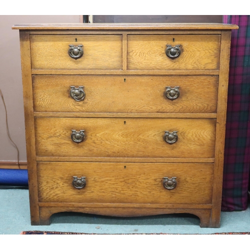 25 - A 20th century oak two over three chest of drawers with stylized drawer pulls, 98cm high x 99cm wide... 