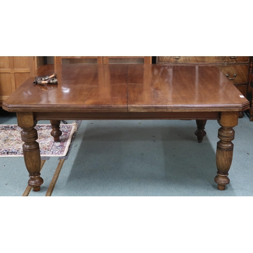 27 - A Victorian mahogany wind out extending dining table on turned supports with two spare leaves, 67cm ... 