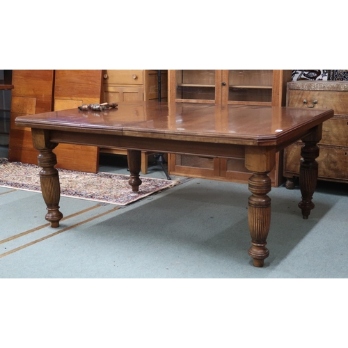 27 - A Victorian mahogany wind out extending dining table on turned supports with two spare leaves, 67cm ... 