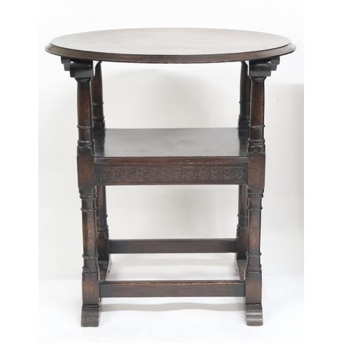 38 - An early 20th century oak metamorphic monks chairs/table with circular top/back over shaped arms on ... 