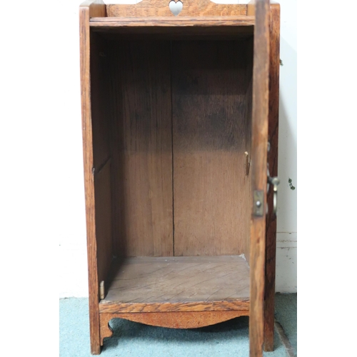 40 - A late Victorian honeyed oak Arts & Crafts bedside cabinet with pierced gallery top over single ... 