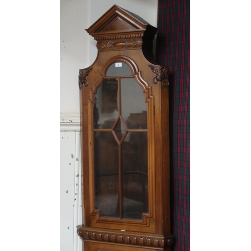 42 - A 20th century reproduction corner display cabinet with architectural style dentil cornice over sing... 