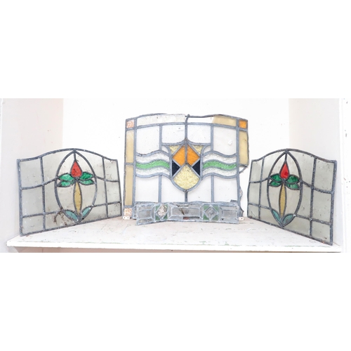 46 - A lot comprising a pair of leaded stained glass panels another larger stained glass panel and three ... 