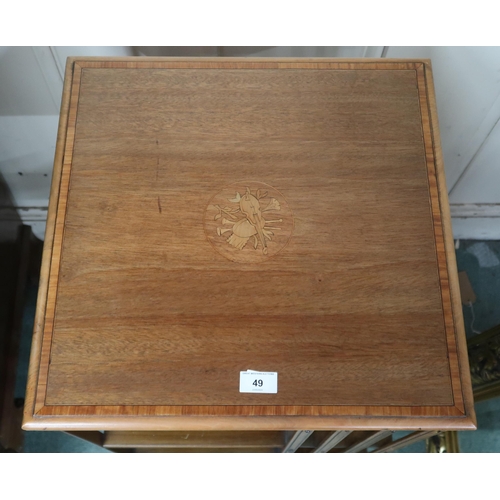 49 - An early 20th century mahogany revolving bookcase with square top over two tiers of shelves with bat... 